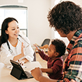 A mother and toddler with a health care provider